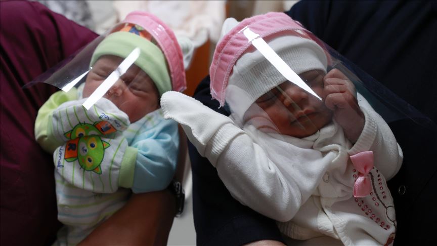 Newborn baby with face shield